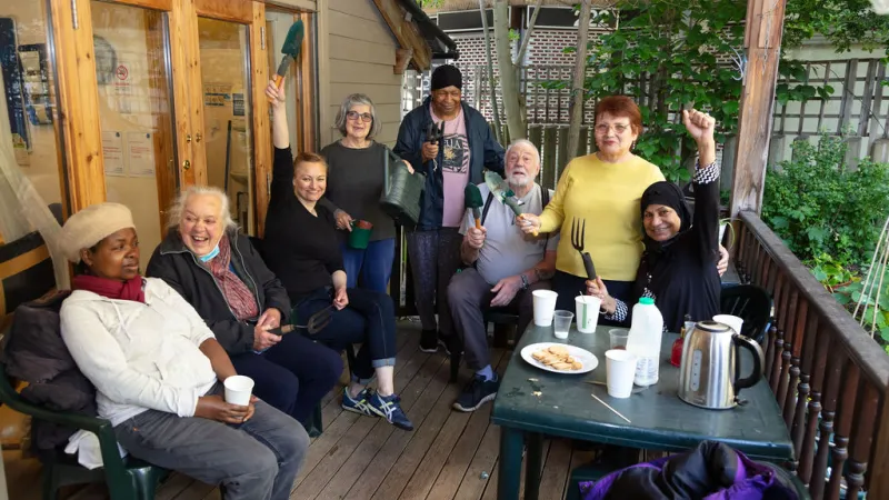 Mixed-gender group of gardening volunteers